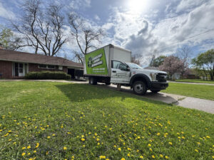 truck in driveway with door open -  Lansing Junk Removal